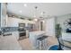 Open-concept kitchen features white cabinets, stainless steel appliances, and center island with seating at 8431 Ocean Tides Cv, Parrish, FL 34219