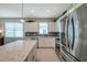 Modern kitchen with granite countertops, stainless steel appliances, and bright natural light at 8431 Ocean Tides Cv, Parrish, FL 34219