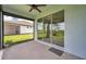 The screened lanai features a ceiling fan and sliding glass doors to the backyard at 8431 Ocean Tides Cv, Parrish, FL 34219