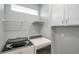 Well-organized laundry room with modern washer and dryer units at 8431 Ocean Tides Cv, Parrish, FL 34219