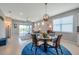 Bright open-concept living room with access to the lanai and views of the backyard at 8431 Ocean Tides Cv, Parrish, FL 34219