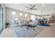 Open-concept living room with neutral colors leading to kitchen with modern appliances and a dining area at 8431 Ocean Tides Cv, Parrish, FL 34219