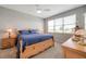 Comfortable main bedroom with a large window, natural light, and stylish wooden furnishings at 8431 Ocean Tides Cv, Parrish, FL 34219