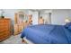 Comfortable bedroom with wooden furniture, and view of bathroom and closet at 8431 Ocean Tides Cv, Parrish, FL 34219