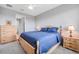 Cozy main bedroom featuring a natural wood bed frame, with view of closet and bathroom at 8431 Ocean Tides Cv, Parrish, FL 34219