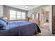 Main bedroom with window view, wooden dressers, and an open doorway to other rooms at 8431 Ocean Tides Cv, Parrish, FL 34219