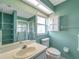 Well-lit bathroom featuring ample counter space, shower, cabinet, and toilet at 9212 Estrada Pl, New Port Richey, FL 34655