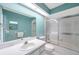 Bright bathroom with a modern vanity, white cabinets and large mirror, complemented by a shower-tub combo at 9212 Estrada Pl, New Port Richey, FL 34655