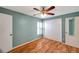 This bedroom is complete with a ceiling fan, plantation shutters, and closet at 9212 Estrada Pl, New Port Richey, FL 34655