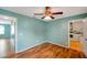Bedroom with a ceiling fan and access to the laundry room at 9212 Estrada Pl, New Port Richey, FL 34655
