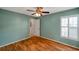 Bright, inviting bedroom featuring a ceiling fan and plantation shutters at 9212 Estrada Pl, New Port Richey, FL 34655