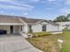 Charming single-story home with a well-manicured lawn, bright exterior paint and a two-car carport at 9212 Estrada Pl, New Port Richey, FL 34655