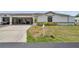 Well-maintained home exterior with carport, showcasing tidy landscaping and a clearly marked address at 9212 Estrada Pl, New Port Richey, FL 34655