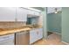 Cozy kitchen with stainless steel appliances, stone countertops and white cabinets at 9212 Estrada Pl, New Port Richey, FL 34655