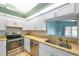Well-equipped kitchen with stainless steel appliances, stone countertops, and bright white cabinets at 9212 Estrada Pl, New Port Richey, FL 34655