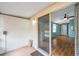 Relaxing covered patio with sliding glass doors leading to a cozy living area with appealing hardwood floors at 9212 Estrada Pl, New Port Richey, FL 34655