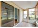 Enclosed patio area featuring a glass sliding door and a door to the outside, offering views of the property at 9212 Estrada Pl, New Port Richey, FL 34655