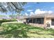 Beautiful backyard featuring a lush lawn, mature trees and a screened in porch at 9334 Whitstone Ct, New Port Richey, FL 34655