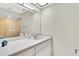 Bright bathroom featuring a skylight and ample counter space at 9334 Whitstone Ct, New Port Richey, FL 34655