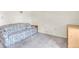 Bright bedroom with floral sofa, side table, and closet at 9334 Whitstone Ct, New Port Richey, FL 34655