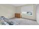 Well-lit bedroom with window, floral sofa, and dresser at 9334 Whitstone Ct, New Port Richey, FL 34655