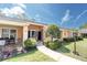 Charming single-story villa with well-maintained landscaping, walkway, and inviting entrance at 9334 Whitstone Ct, New Port Richey, FL 34655