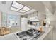 Well-lit kitchen features white appliances, ample counter space, and a skylight at 9334 Whitstone Ct, New Port Richey, FL 34655