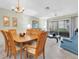 Open-concept living room and dining area featuring neutral tones and a sliding glass door to the patio at 9334 Whitstone Ct, New Port Richey, FL 34655