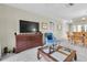 Open living area leads into dining area, features a flat screen TV and comfortable chair at 9334 Whitstone Ct, New Port Richey, FL 34655