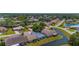 Overhead shot of houses in a quiet neighborhood, surrounded by green trees and a pond at 9407 Burnam Dr, Weeki Wachee, FL 34613