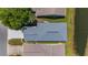 Birds-eye view of home's roof, neighboring house and adjacent pond providing sense of lot size and neighborhood context at 9407 Burnam Dr, Weeki Wachee, FL 34613