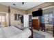 Comfortable bedroom with neutral walls, wooden furniture, and a large window for natural light at 9407 Burnam Dr, Weeki Wachee, FL 34613