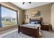 Comfortable bedroom featuring a large window with backyard views, providing natural light and a relaxing atmosphere at 9407 Burnam Dr, Weeki Wachee, FL 34613