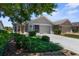 Front view of the house with a gray exterior, showcasing the well-manicured front yard and attached garage at 9407 Burnam Dr, Weeki Wachee, FL 34613