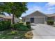Charming home with a two-car garage, well-maintained lawn, and beautiful landscaping at 9407 Burnam Dr, Weeki Wachee, FL 34613