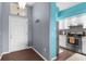 Inviting home entrance with a gray wall, a white front door and adjacent kitchen area at 9407 Burnam Dr, Weeki Wachee, FL 34613