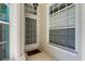 Welcoming front porch with tiled flooring, large windows, and a charming entryway, providing natural light at 9407 Burnam Dr, Weeki Wachee, FL 34613