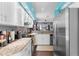 Modern kitchen with granite countertops, stainless steel appliances, and open layout flowing into the living area at 9407 Burnam Dr, Weeki Wachee, FL 34613