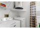 Functional laundry room with modern appliances, overhead shelving, and ample space at 9407 Burnam Dr, Weeki Wachee, FL 34613