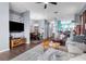 Spacious living room featuring modern decor, wood floors, and an open floor plan to dining area at 9407 Burnam Dr, Weeki Wachee, FL 34613