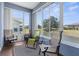Relaxing sunroom with large windows offering picturesque views of the backyard and pond at 9407 Burnam Dr, Weeki Wachee, FL 34613