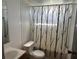 Bathroom features a white sink and toilet, plus a shower with a decorative curtain at 9444 Loras St, New Port Richey, FL 34654