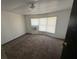 Neutral bedroom with carpet, natural light, and a simple color palette at 9444 Loras St, New Port Richey, FL 34654