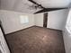 Bedroom featuring a large window, neutral walls, and brown carpet at 9444 Loras St, New Port Richey, FL 34654