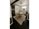 Cozy dining room with a round table, four chairs, and modern decor, with a partial view of the kitchen at 9444 Loras St, New Port Richey, FL 34654