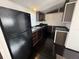 Well-lit kitchen featuring sleek black appliances, efficient layout, and ample counter space at 9444 Loras St, New Port Richey, FL 34654