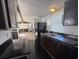 Functional kitchen features dark cabinetry, a stainless steel sink, and ample counter space at 9444 Loras St, New Port Richey, FL 34654