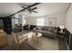 Bright living room showcasing modern furniture, a ceiling fan, and large windows for natural light at 9444 Loras St, New Port Richey, FL 34654