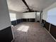 Expansive living room with neutral carpeting, multiple windows, and ample space for furnishings at 9444 Loras St, New Port Richey, FL 34654