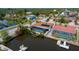 Waterfront home featuring a screened-in pool, dock, and solar panels for a luxurious outdoor lifestyle at 9810 San Sebastian Way, Port Richey, FL 34668